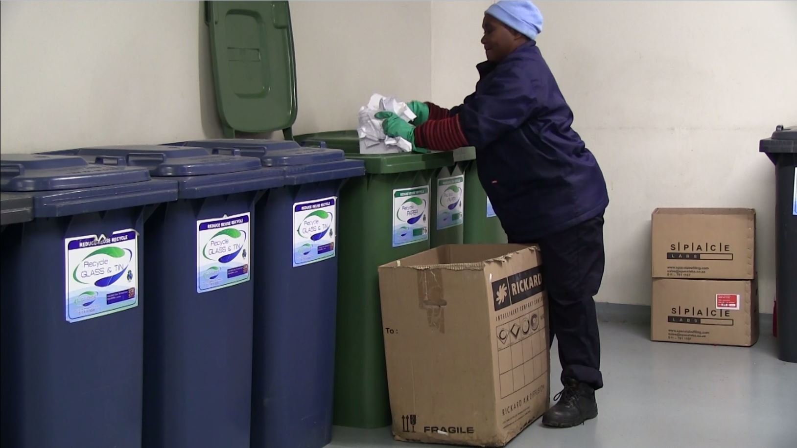 woman dumping waste into a bin